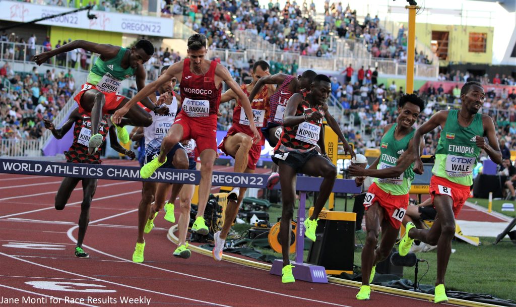 Soufiane El Bakkali of Morocco celebrates (center) on his way to winning the 2022 World Athletics Championships Oregon22  steeplechase title (photo by Jane Monti for Race Results Weekly)