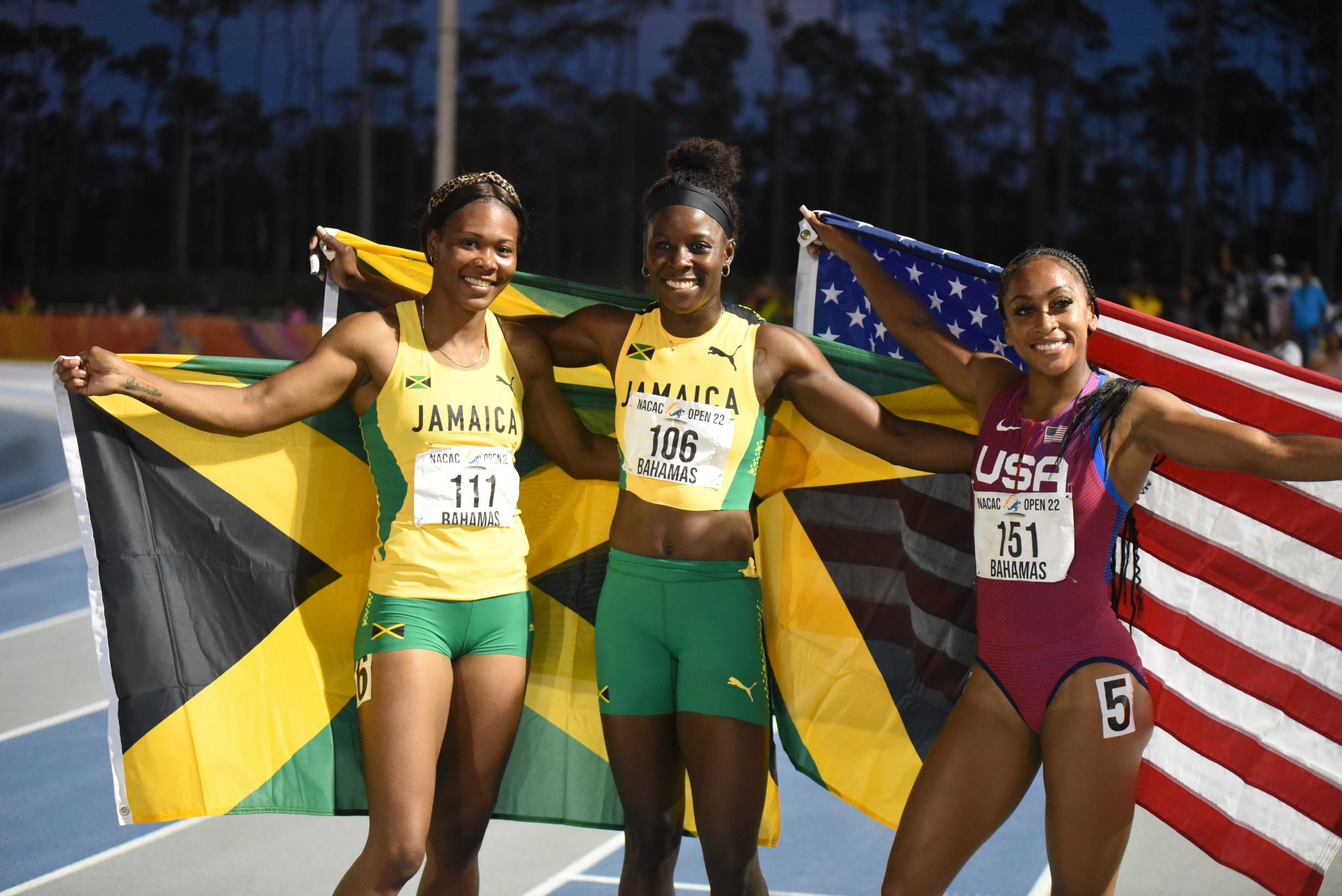 Shericka Jackson, after winning the women's 100m in a championship record 10.83, pose with bronze medallist Natasha Morrison, at the NACAC Open Championships in Freeport, Grand Bahamas.