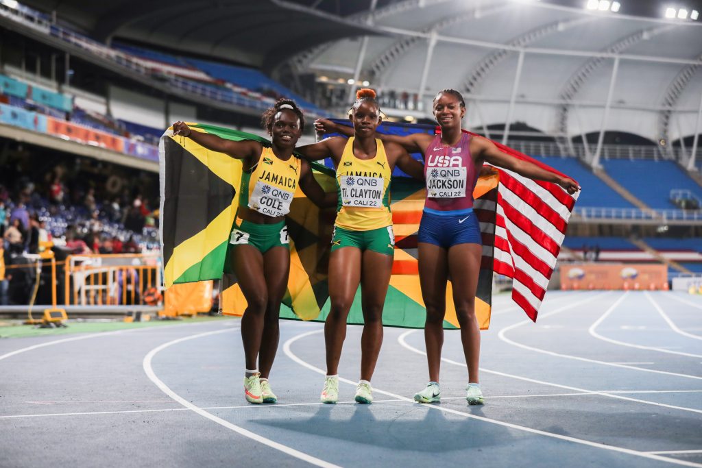 Tina Clayton, centre, Serena Cole, left, and Shawnti Jackson celebrate after the women's 100m final at the World U20 Championships in Cali, Colombia