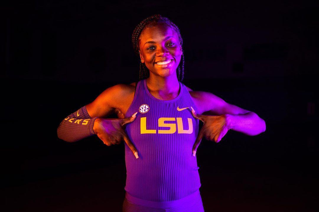 LSU freshman sprinter Brianna Lyston breaking a personal record in the 60m dash at the 2023 Tyson Invitational, smiling and looking determined on the starting line.