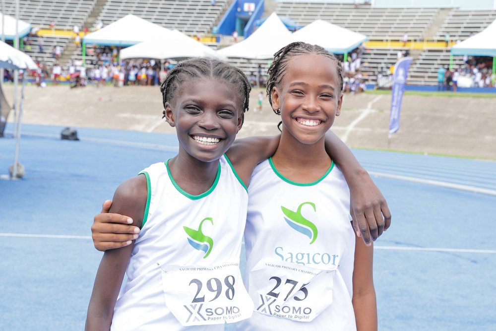 St. Andrew teammates Sanique Watt and Brianna Ashman are all smiles after placing 1st and 6th respectively in the girls’ high jump open finals.