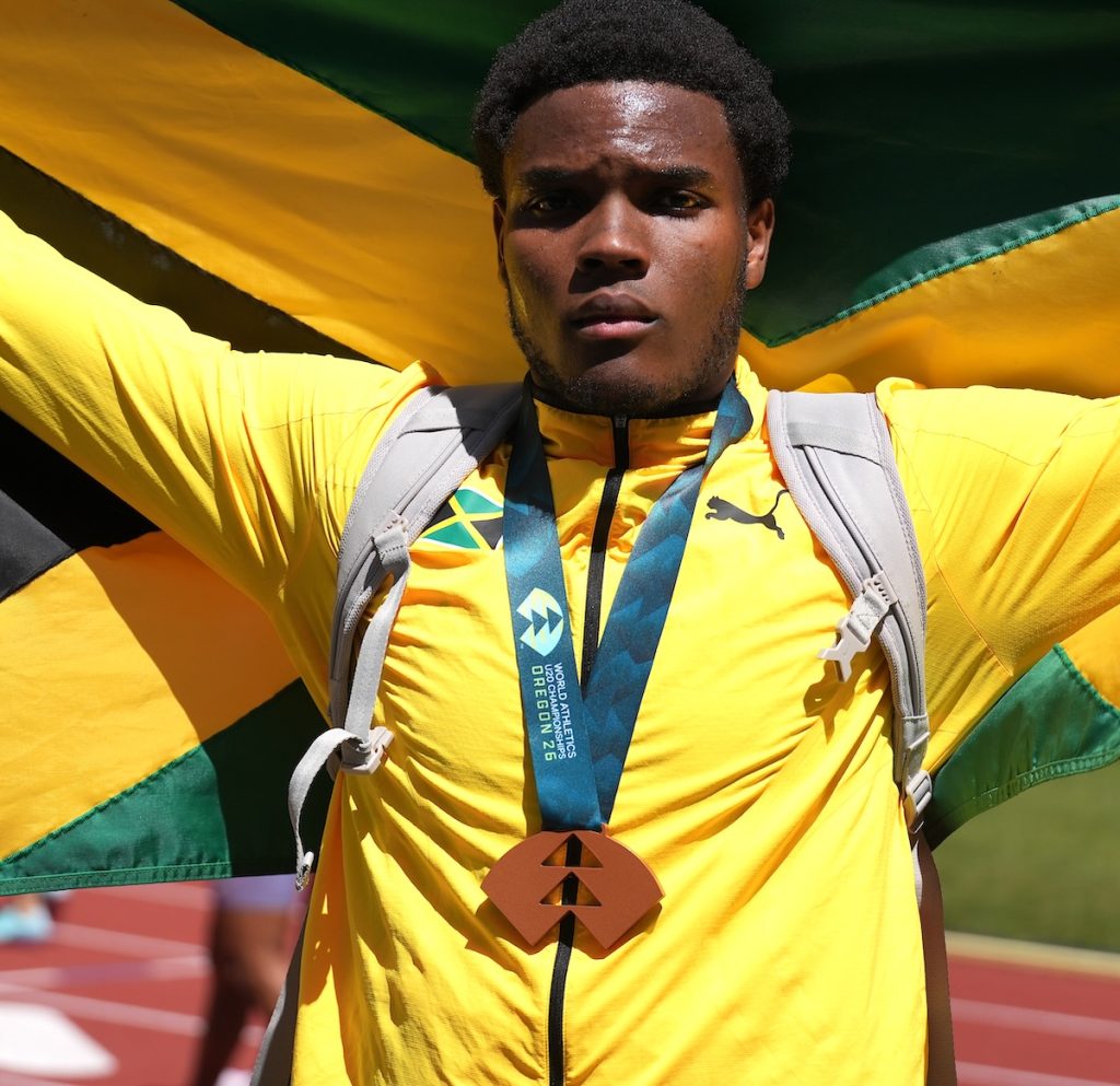 Jamaica’s Joseph Salmon proudly poses with his bronze medal and the Jamaican flag after throwing 64.37m to finish third in the men’s discus final at the World U20 Championships. Teammate Kamari Kennedy placed fourth with a personal-best 64.18m.